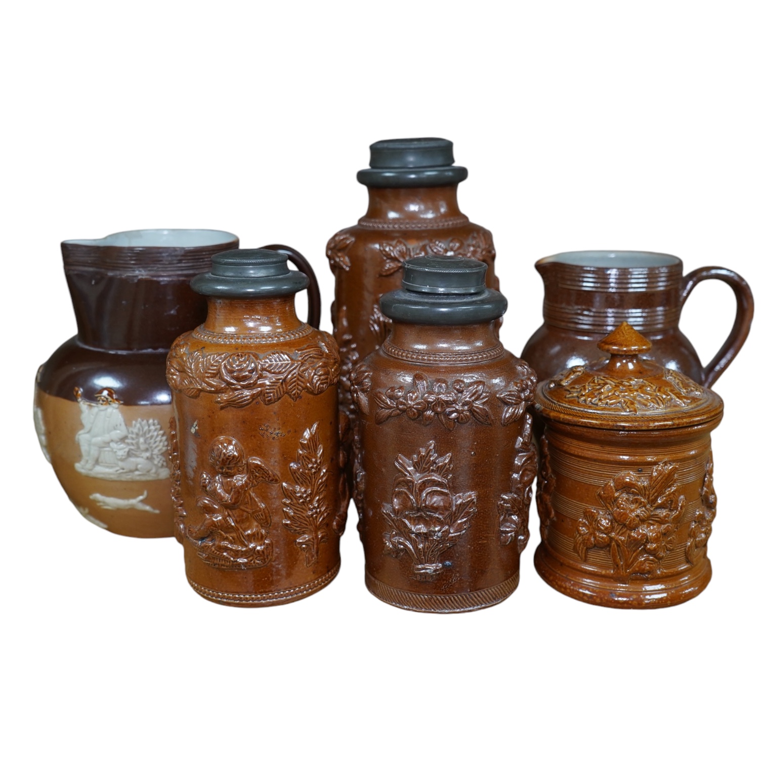 Four 19th century Derbyshire lead glazed stoneware jars and a stoneware jug and another, tallest 21cm (6). Condition - poor to fair